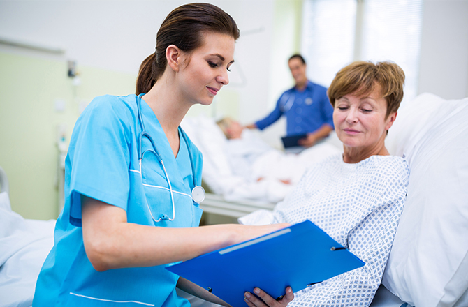 An elderly woman is talking with a doctor.