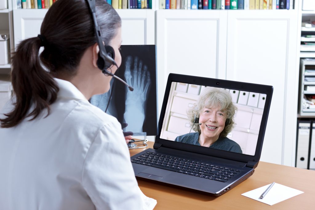 Nurse consulting Patient via Telehealth during COVID-19