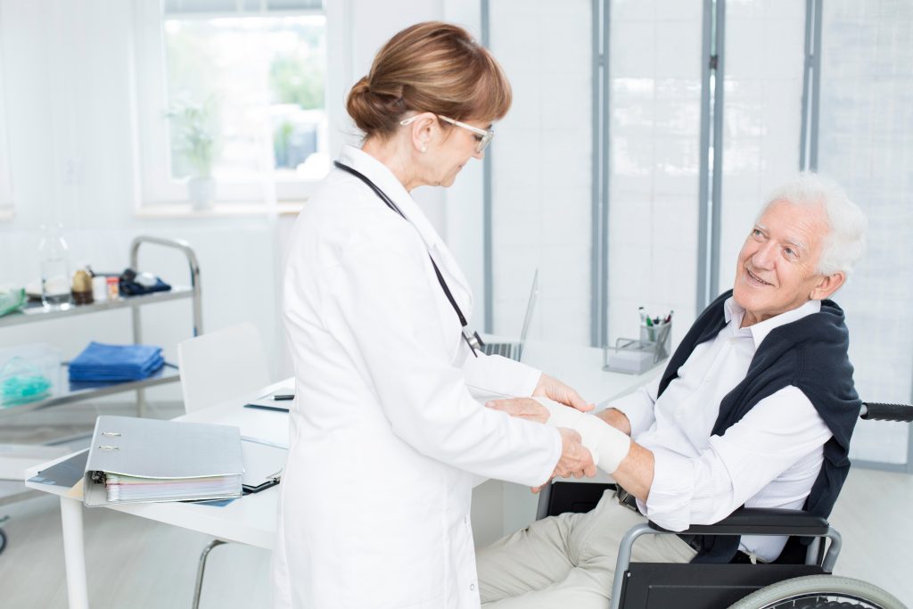 Nurse wrapping wounded hand