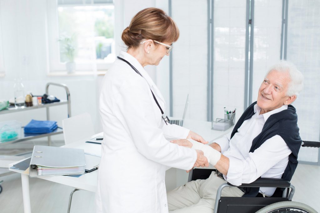 Nurse wrapping wounded hand
