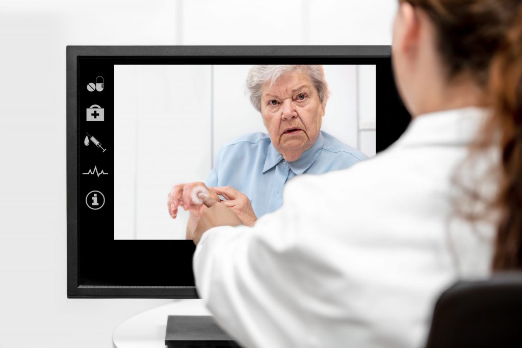 Nurse consulting Patient via Telehealth during COVID-19