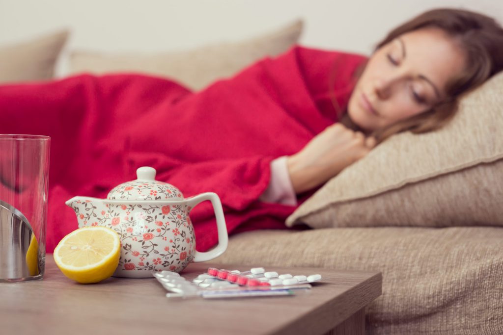 Sick woman sleeping on bed