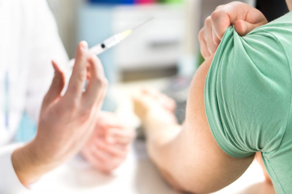 nurse gives an injection to patient