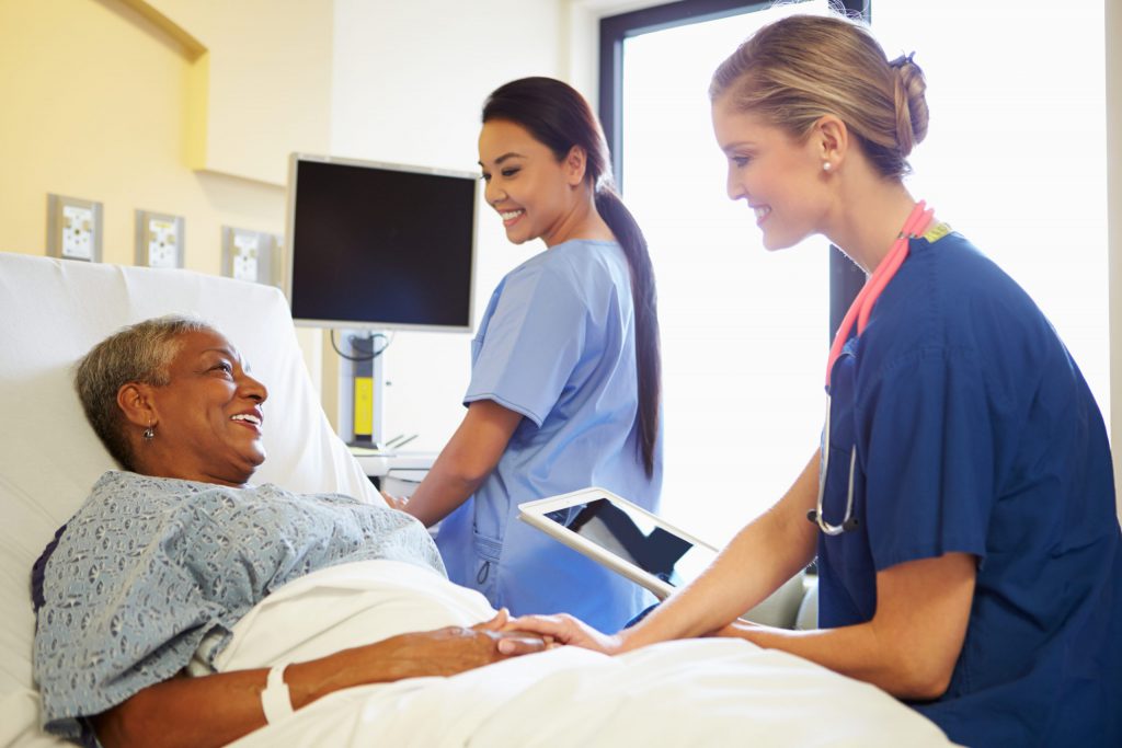 Nurseshappilycommunicatingwithpatient