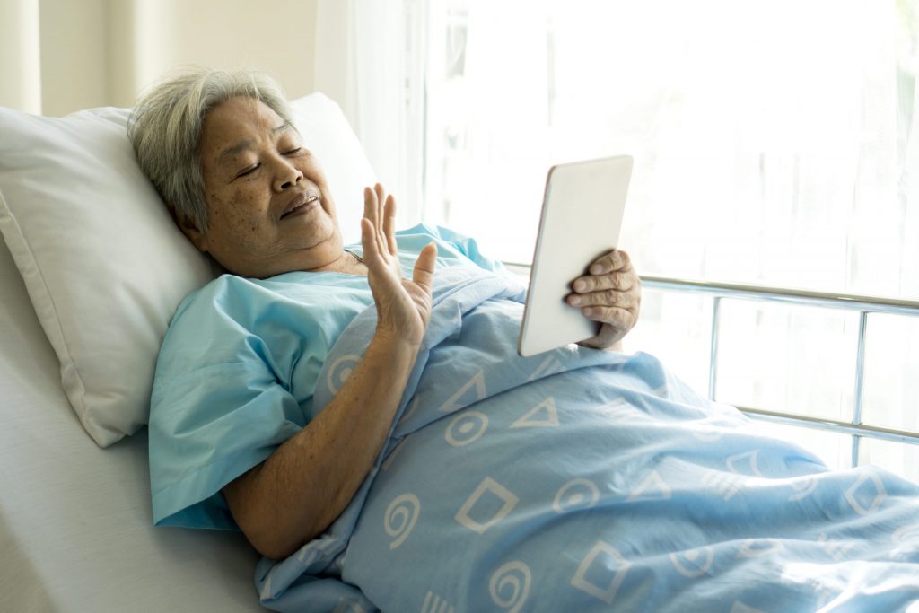 Elderly patient using digital tablet