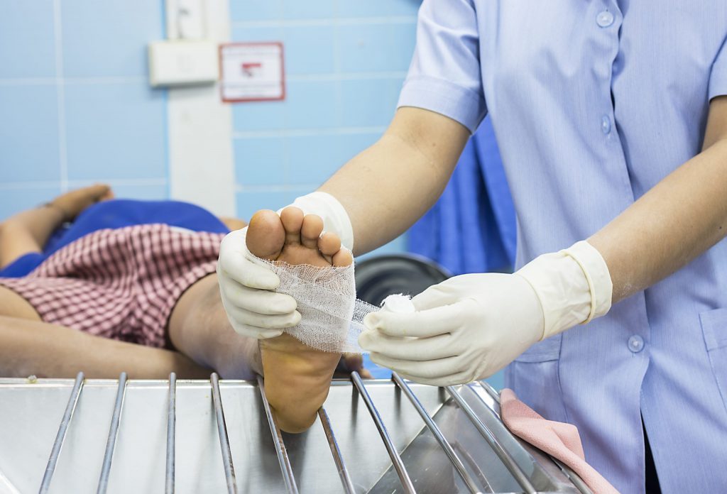 Doctor Bandaging Patients Leg