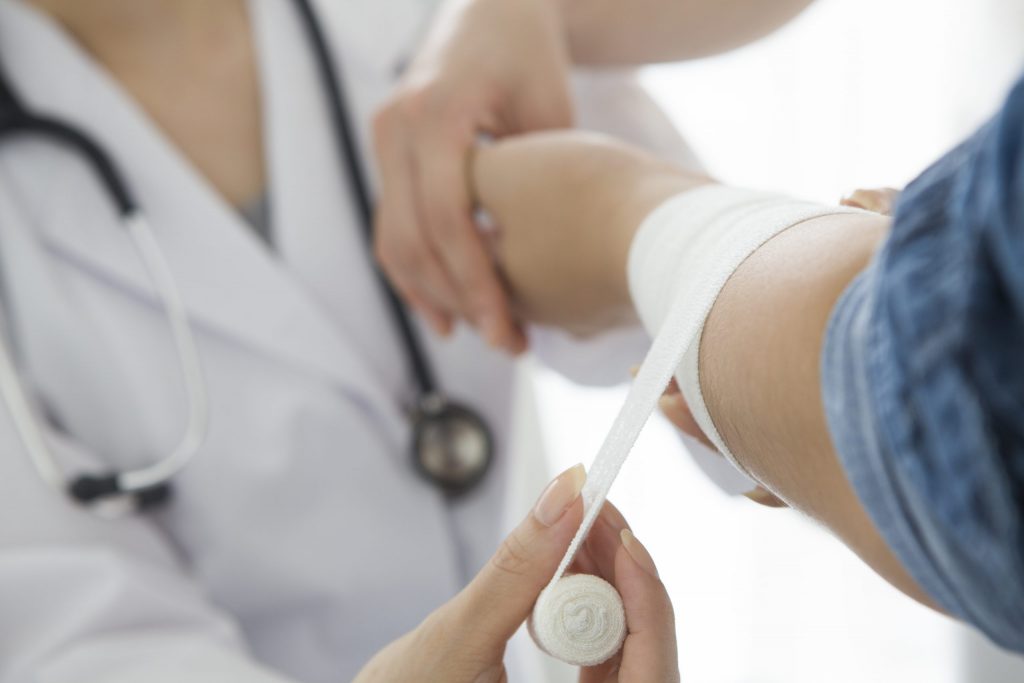 Nurse Bandaging Patients hand