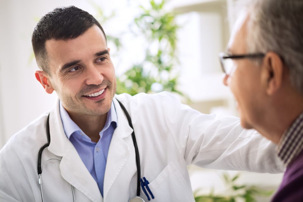 Male doctor consulting patient in clinic