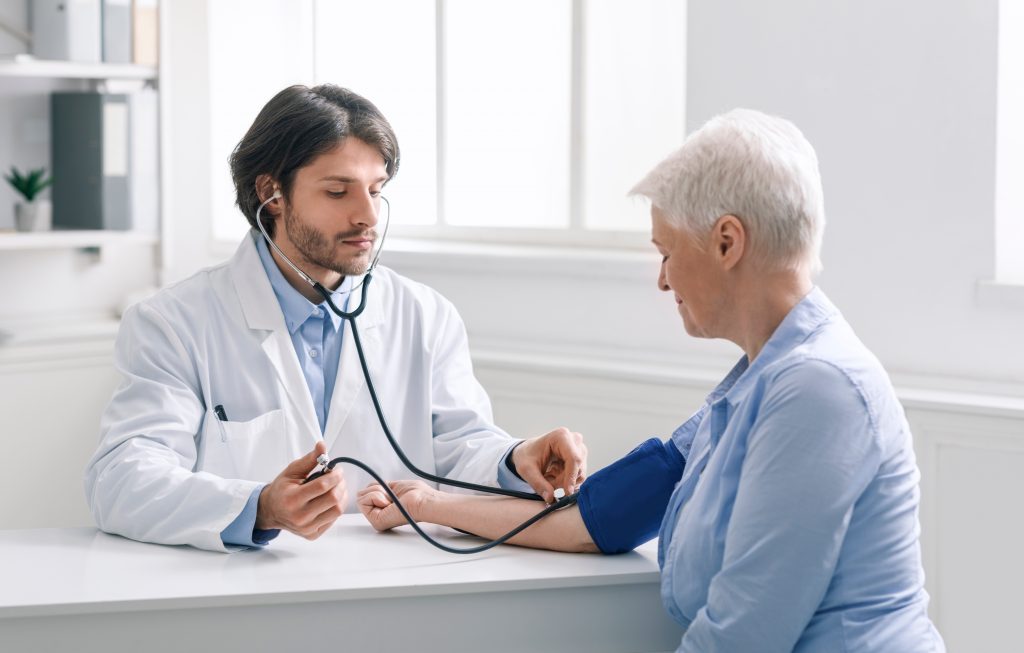 Physician Checking Patient's Blood Pressure