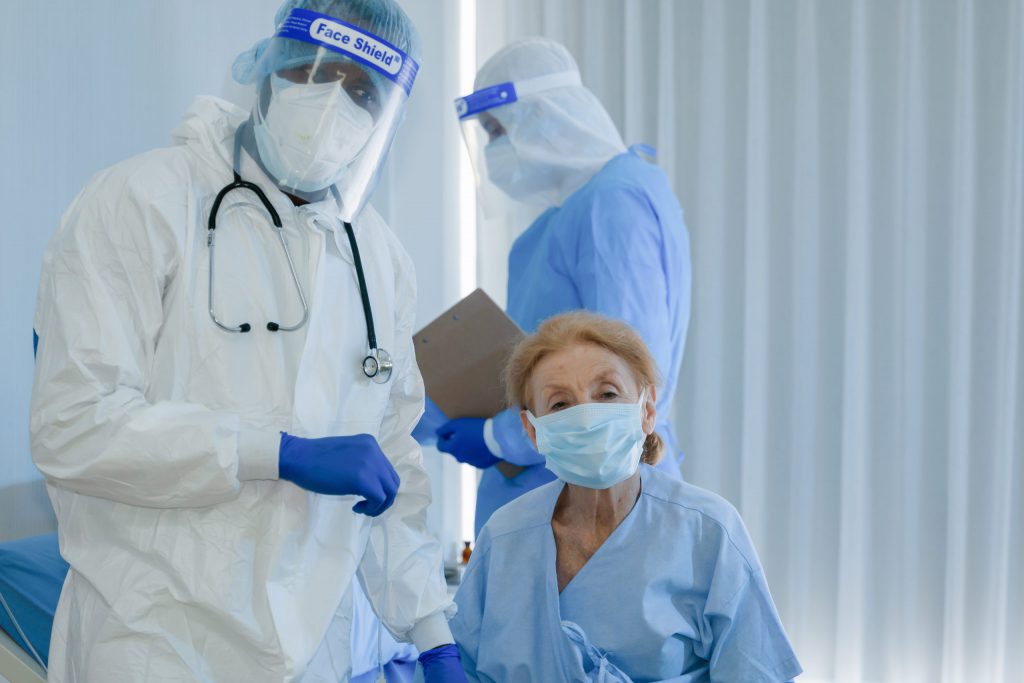 Physician with PPE kit Checking Patient