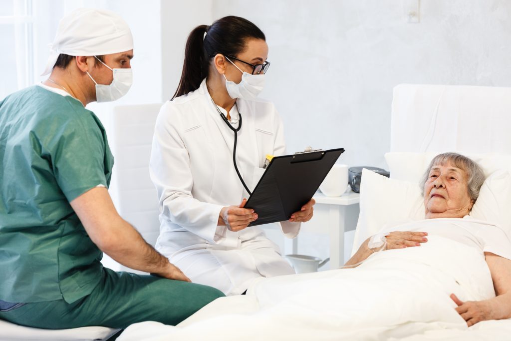 Doctor and Nurse Communicating with Patient