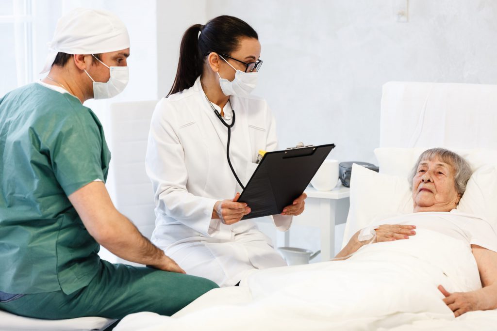 Doctor and Nurse Communicating with Patient
