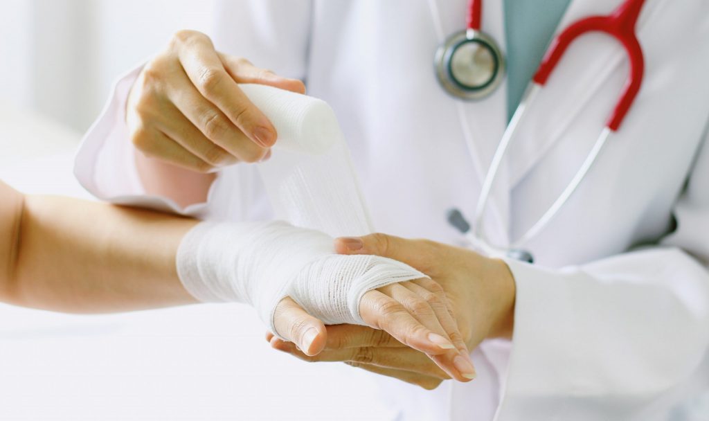 Doctor Wrapping a Wrist