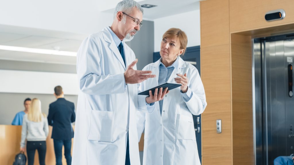 Physician checking patient's report