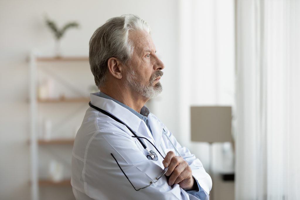 Doctor Looking Out The Window Lost in Thought