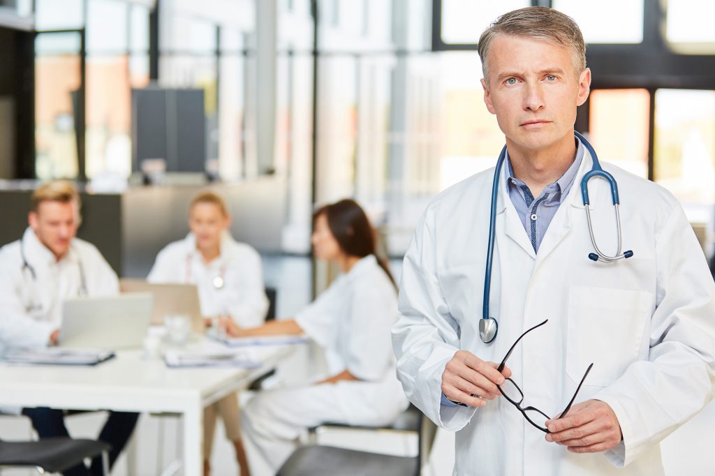 Senior Physician in Front of his Medical Team