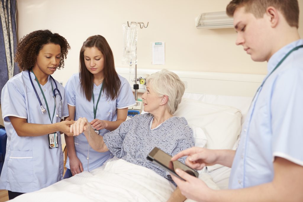 Nursing staff by Female Patient in Hospital