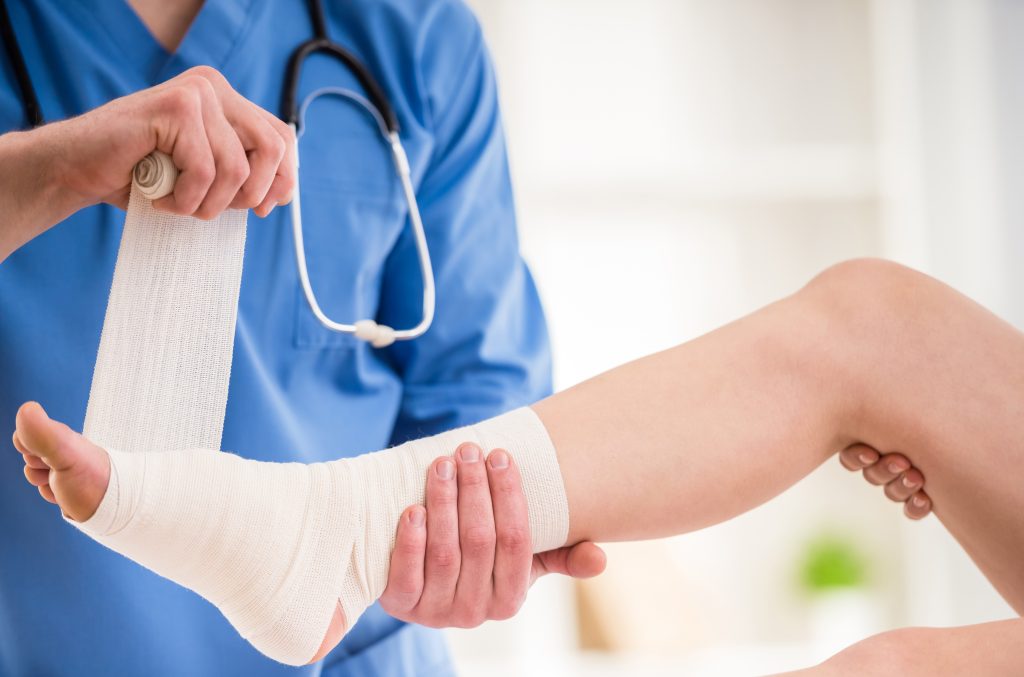 Doctor Bandaging a Patient Foot