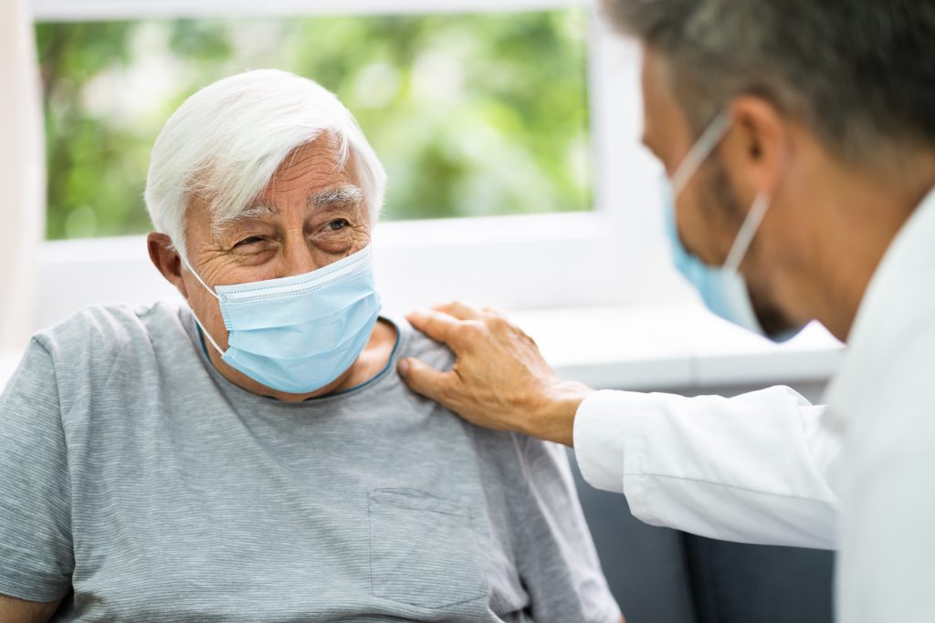 Doctor Attending Elderly Patients At Home