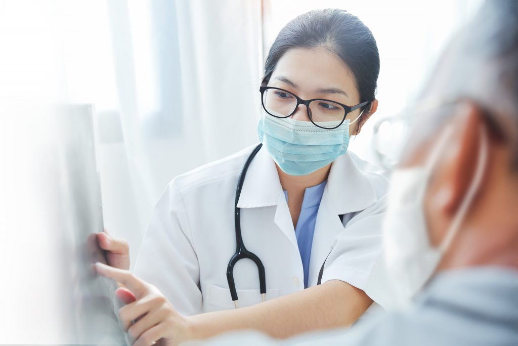 Female Doctor Attending Elderly Patient