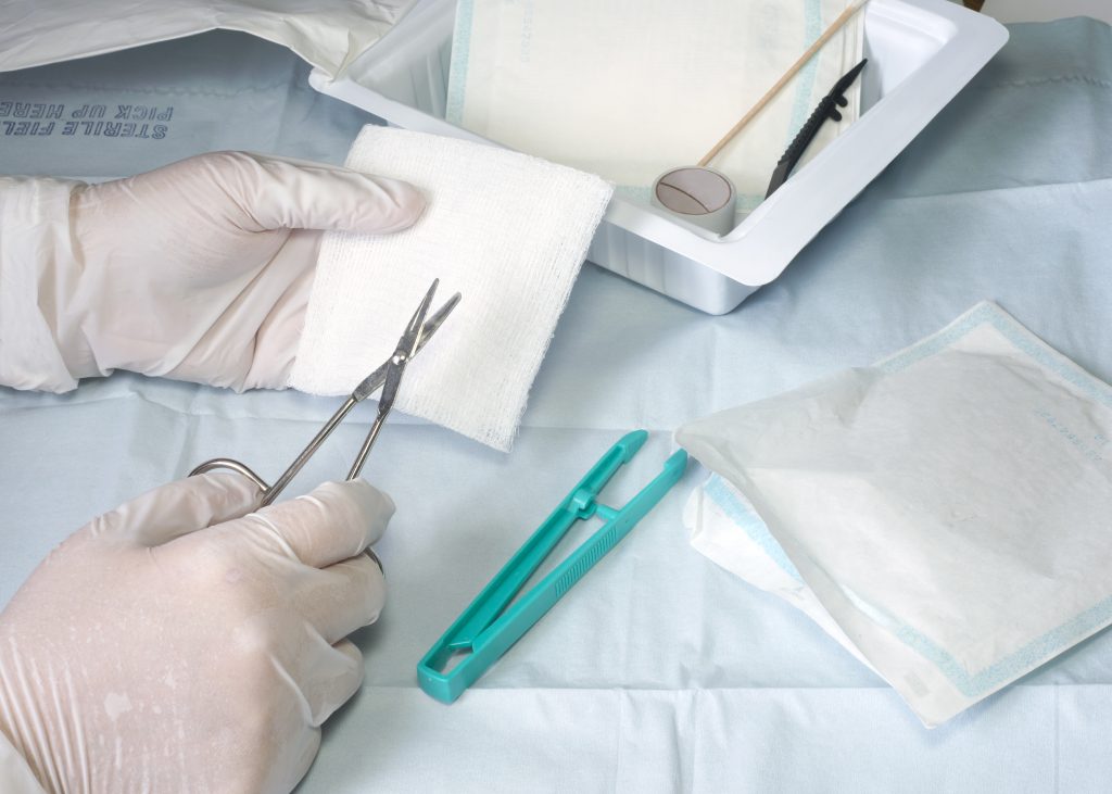Nurse Prepares Materials for Wound Dressing