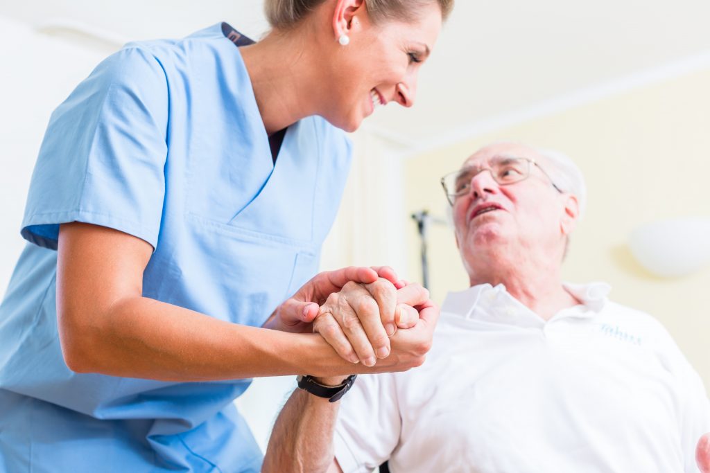 Nurse Holding old man's Hand