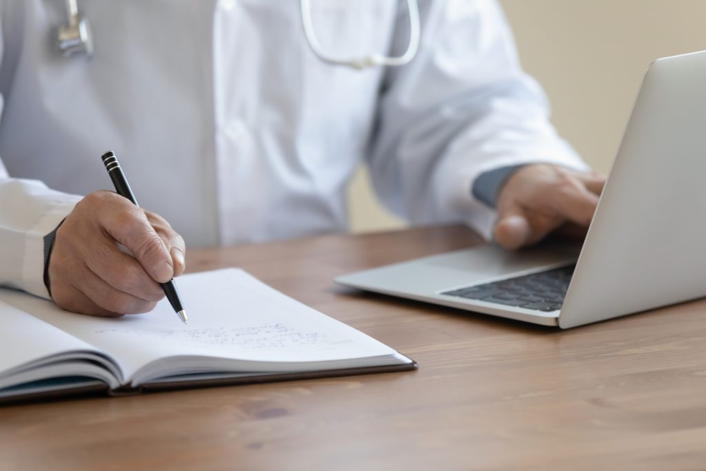 Physician Taking Notes